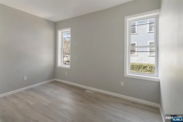 an empty room with windows and closet