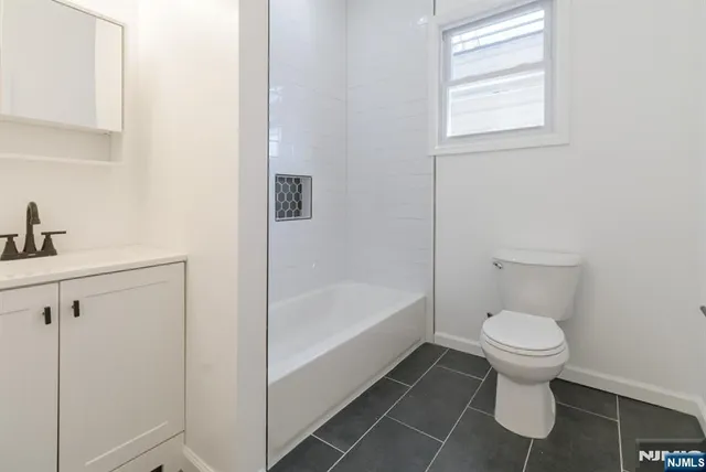 a bathroom with a toilet and a bathtub