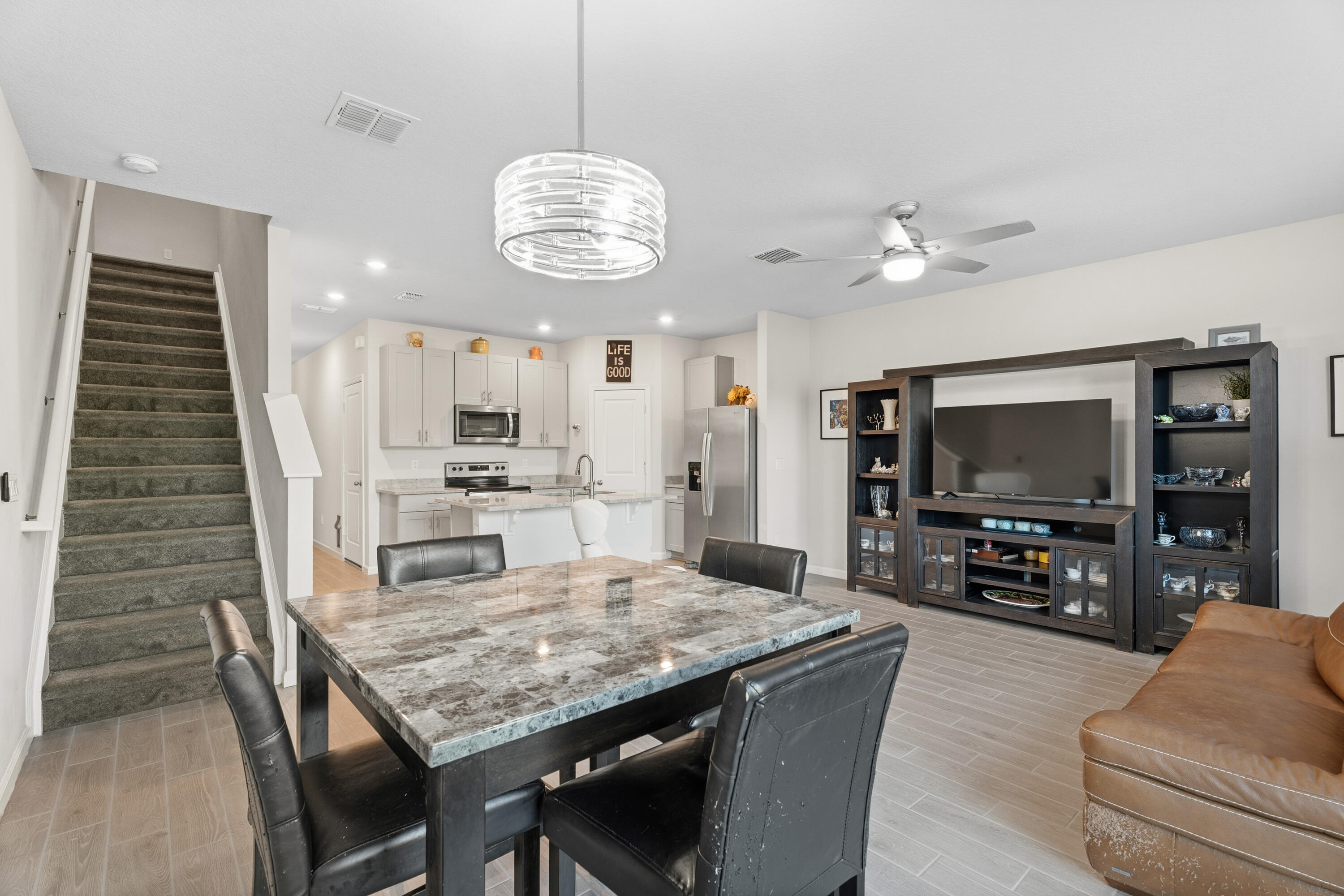 3931 Southeast Mentmore Lane Stuart, FL 34997 - Photo 12 of 33 a view of a dining room with furniture a chandelier and wooden floor