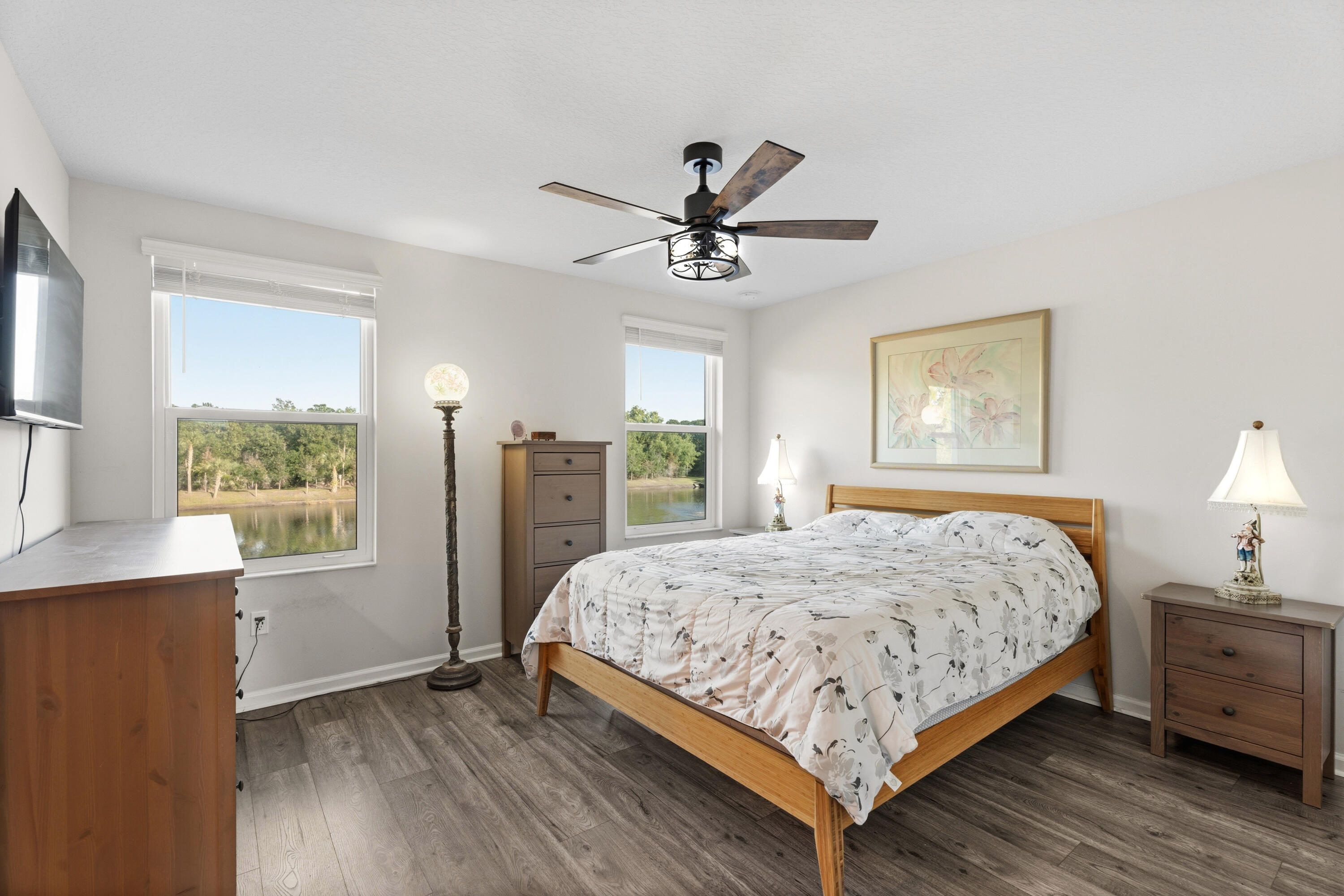 3931 Southeast Mentmore Lane Stuart, FL 34997 - Photo 14 of 33 a bedroom with a large bed a chandelier and a window
