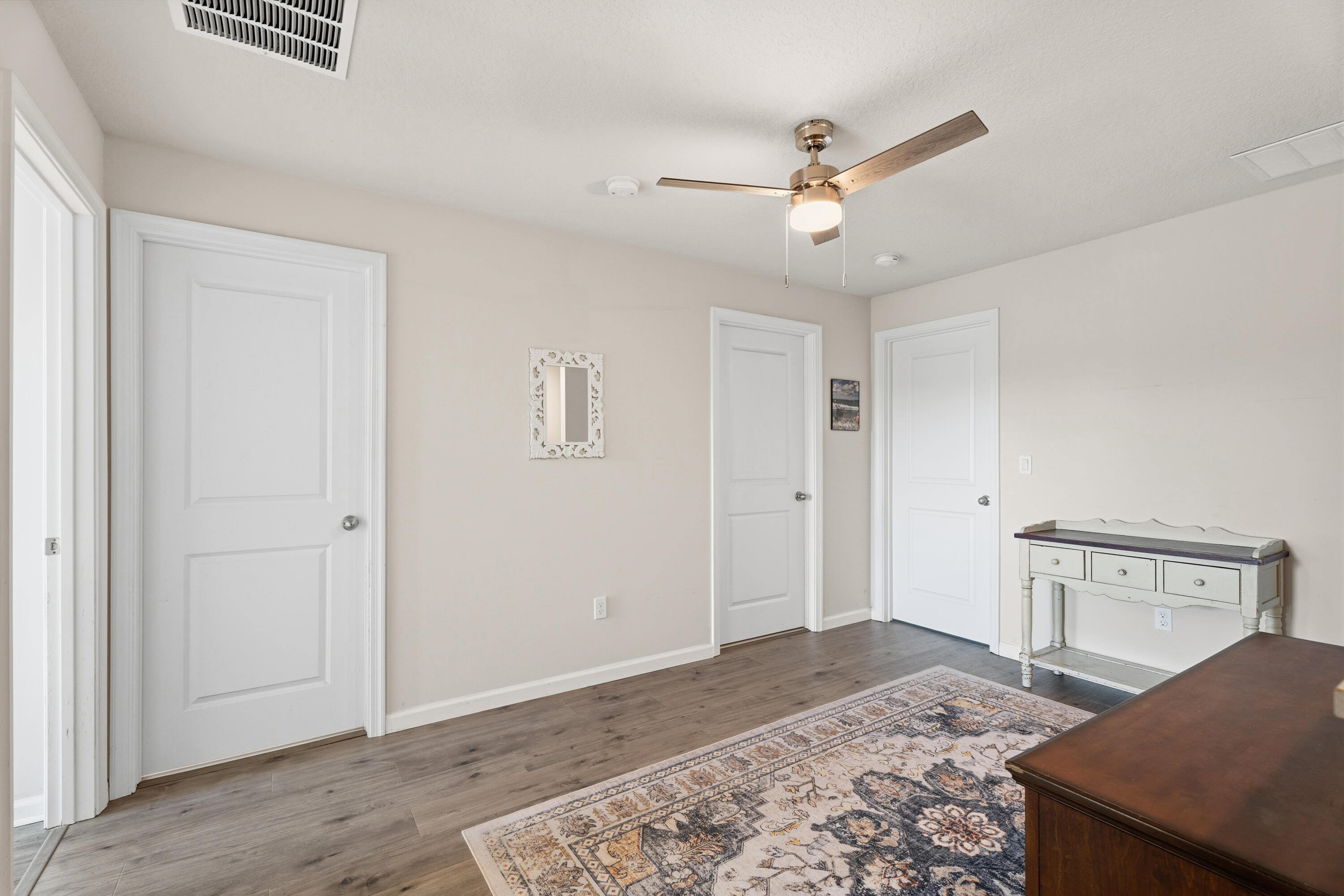 3931 Southeast Mentmore Lane Stuart, FL 34997 - Photo 23 of 33 a view of a livingroom with wooden floor and a ceiling fan