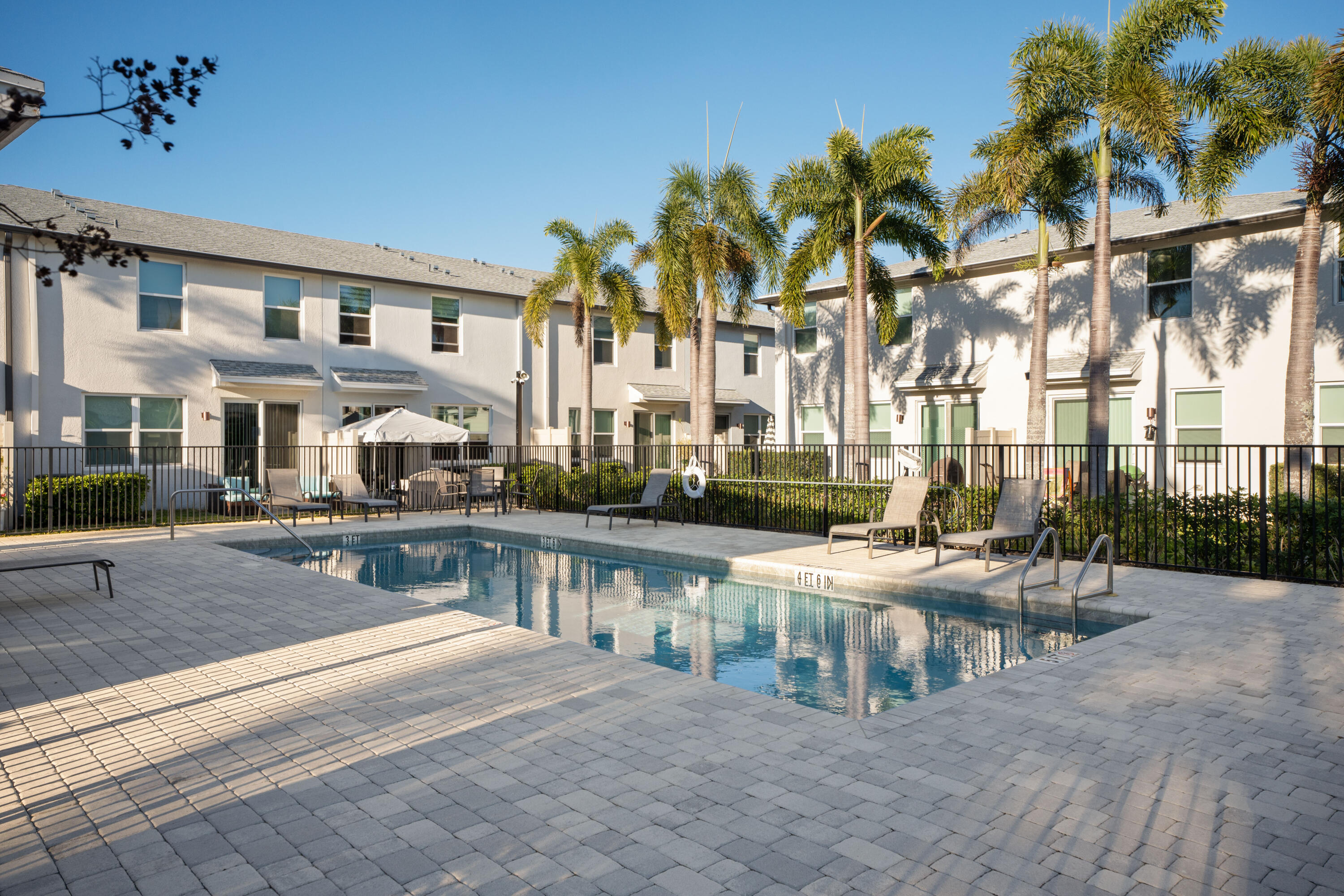 3931 Southeast Mentmore Lane Stuart, FL 34997 - Photo 33 of 33 a view of a patio with couches table and chairs and potted plants