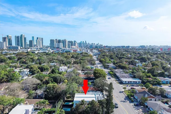 a view of house with a backyard and a patio