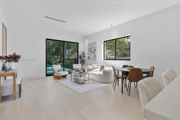 a living room with furniture and wooden floor