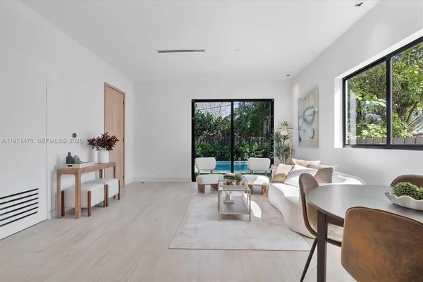a view of a dining room with furniture and wooden floor