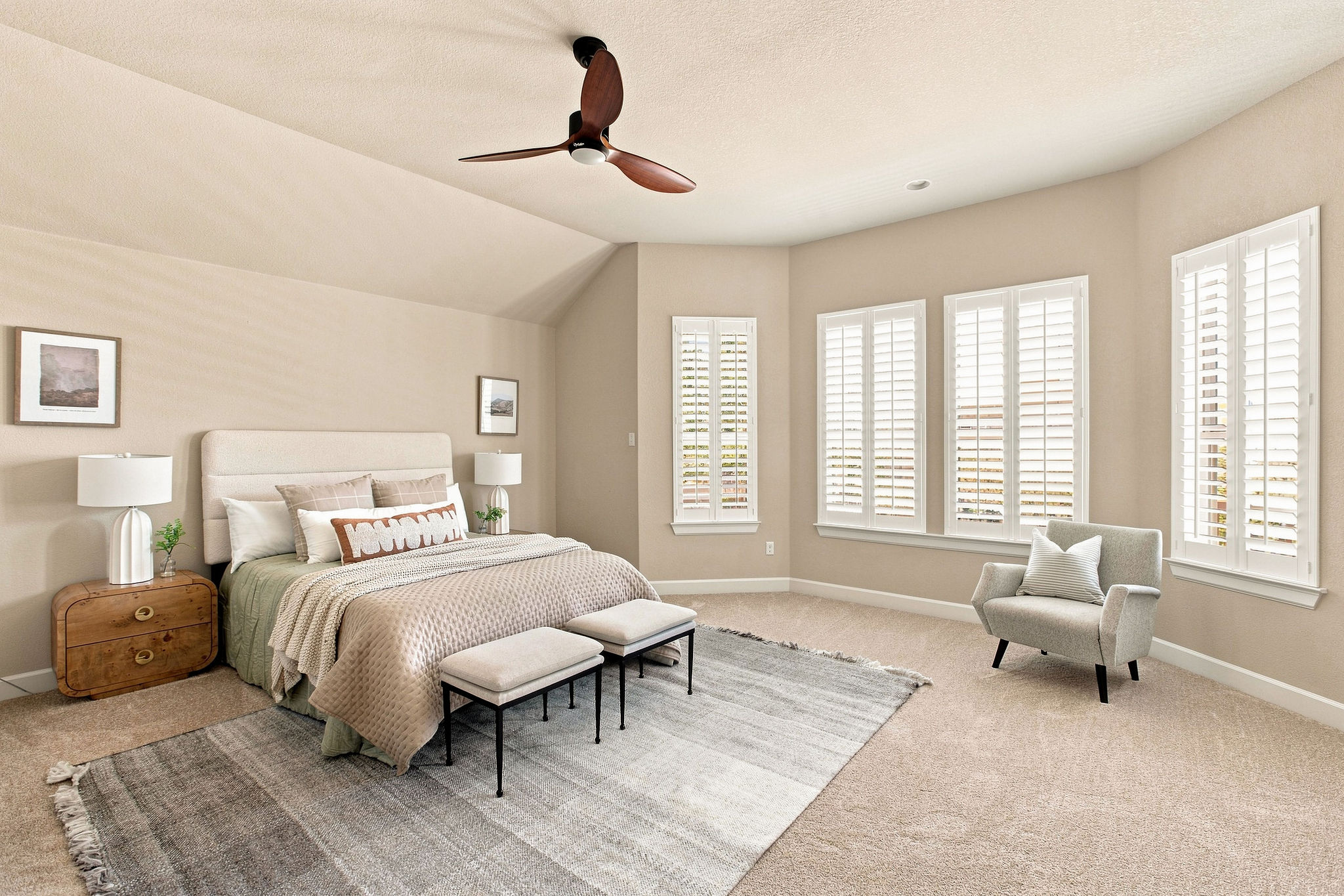 6100 Gunnison Turn Road Austin, TX 78738 - Photo 25 of 34 An angled ceiling and clean plantation shutters frame a relaxing, carpeted bedroom space.