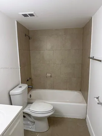 a bathroom with a toilet and a bath tub