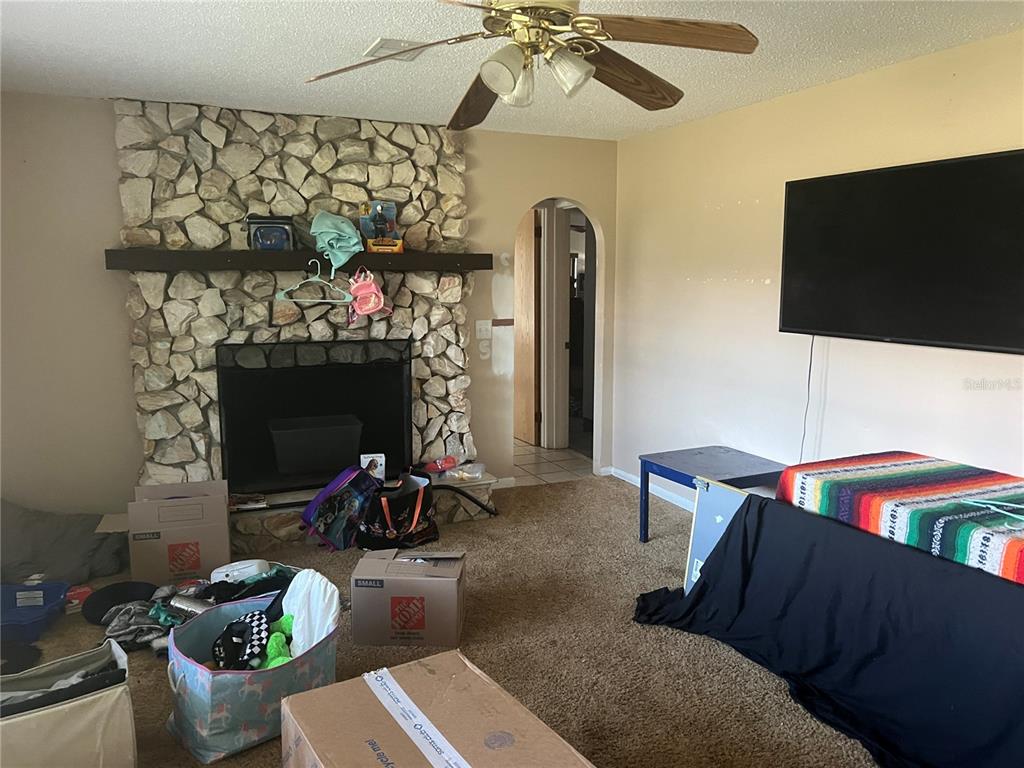 6766 264th Street Branford, FL 32008 - Photo 14 of 23 a living room with furniture a flat screen tv and a fireplace