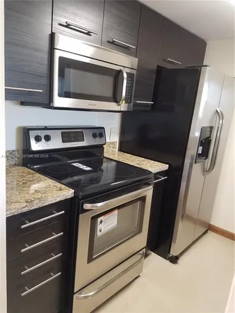 a stove top oven sitting inside of a kitchen