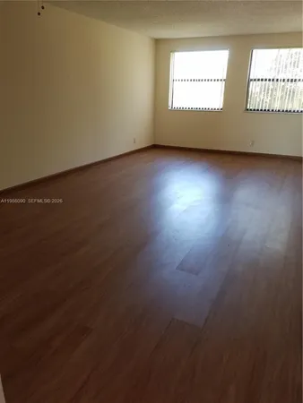 a view of an empty room and a window