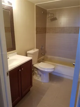 a bathroom with a toilet a sink and bathtub