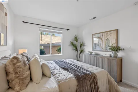 a bedroom with a large bed and a window