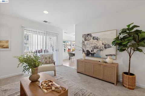 a living room with furniture flowerpot and a potted plant