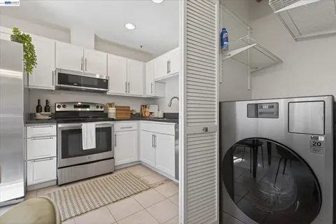 a kitchen with a stove top oven and cabinets
