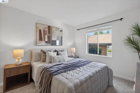 a bedroom with a large bed and a window