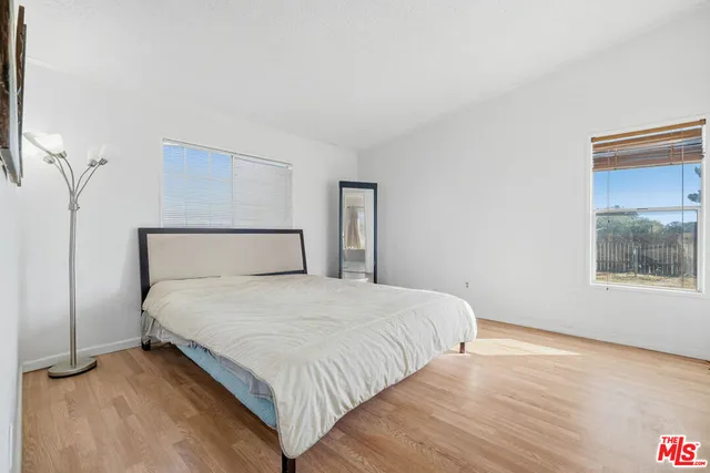 a bedroom with a bed and a night stand