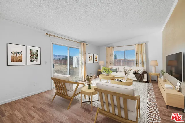 a view of a livingroom with furniture and a flat screen tv
