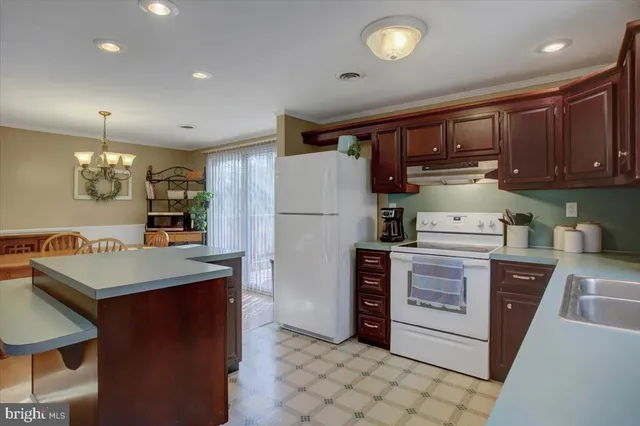 a kitchen with refrigerator cabinets and wooden floor