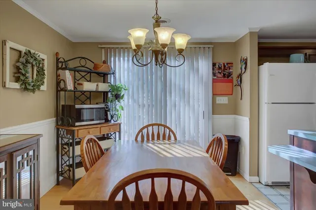a view of a dining room with furniture and chandelier