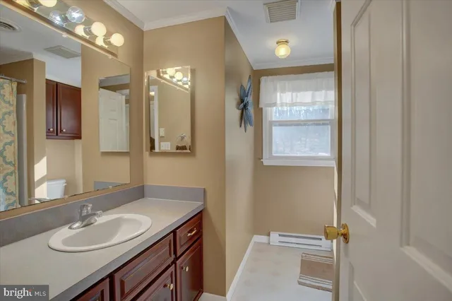 a bathroom with a sink vanity granite and a mirror