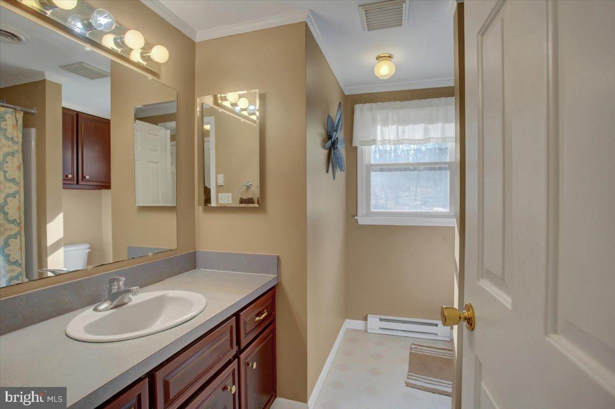 10744 Coral Ridge Road Fayetteville, PA 17222 - Photo 16 of 40 a bathroom with a sink vanity granite and a mirror