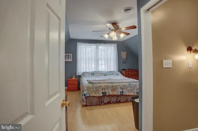 a bedroom with a bed and chandelier