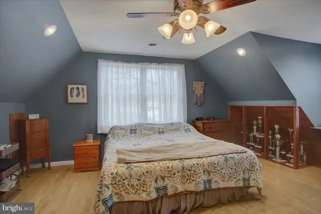 a bedroom with a large bed and a chandelier