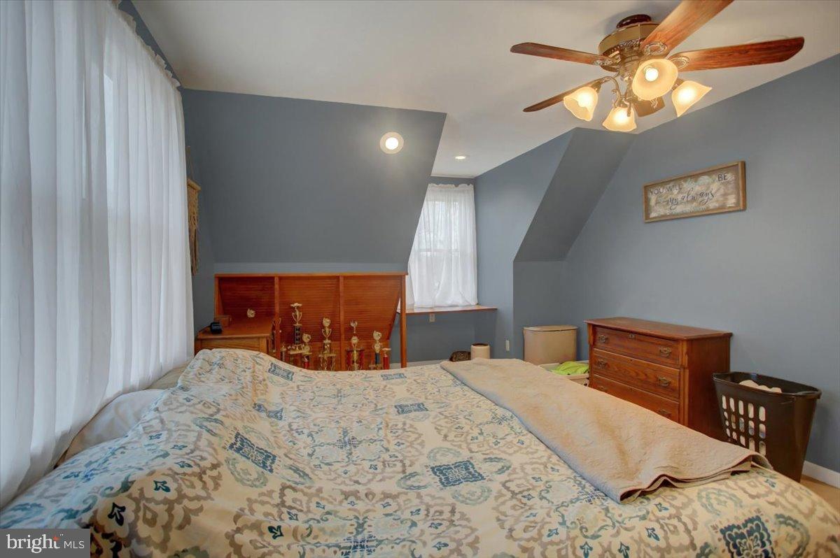10744 Coral Ridge Road Fayetteville, PA 17222 - Photo 23 of 40 a bedroom with a bed and a chandelier