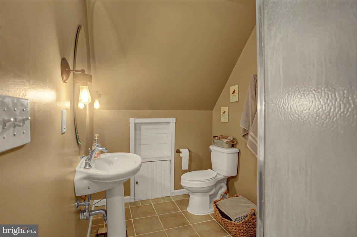 10744 Coral Ridge Road Fayetteville, PA 17222 - Photo 24 of 40 a bathroom with a sink toilet and a mirror