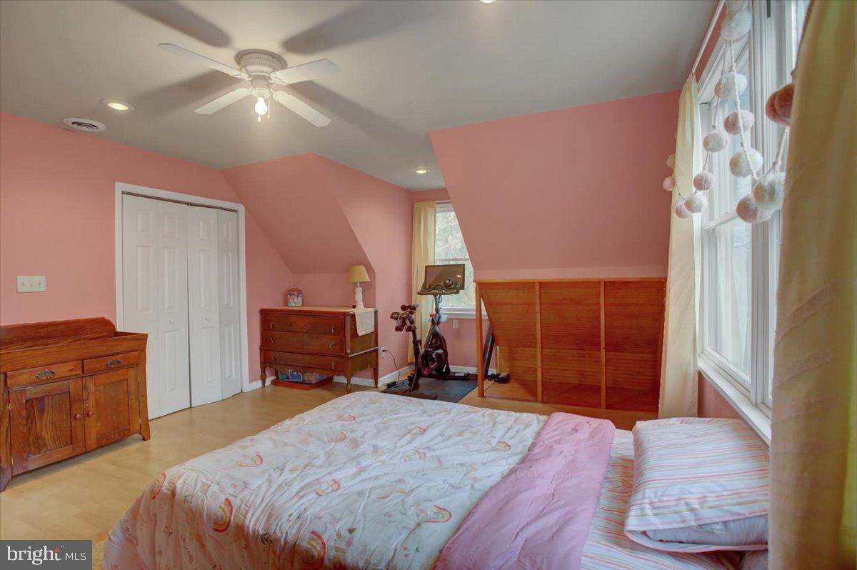 10744 Coral Ridge Road Fayetteville, PA 17222 - Photo 27 of 40 a bedroom with a bed and a chandelier