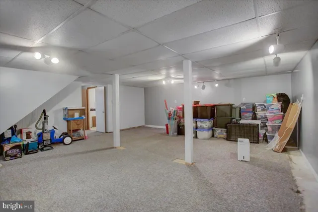 a view of a big room with air conditioner duct and materials on floor