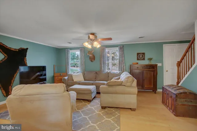 a living room with furniture and a chandelier