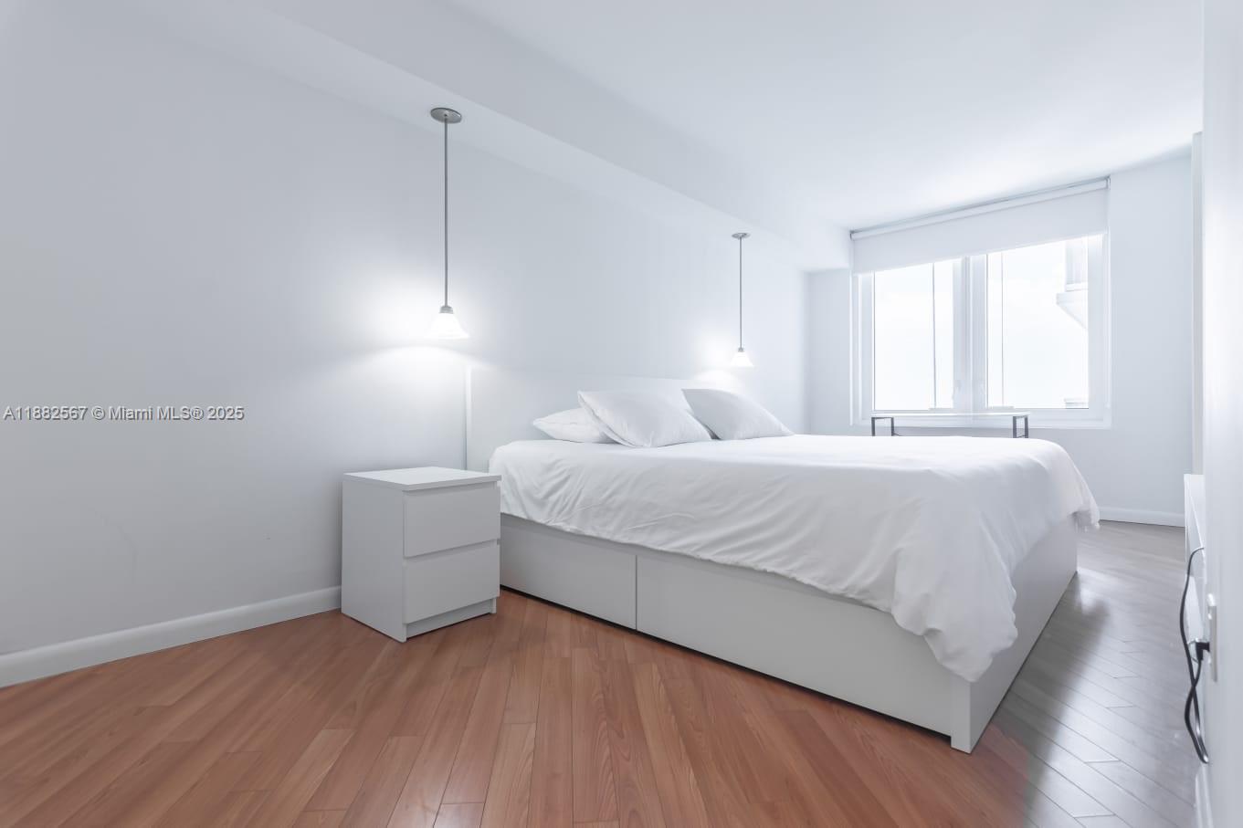 2301 Collins Avenue, Unit 1023 Miami Beach, FL 33139 - Photo 12 of 15 a bedroom with a bed and a night stand