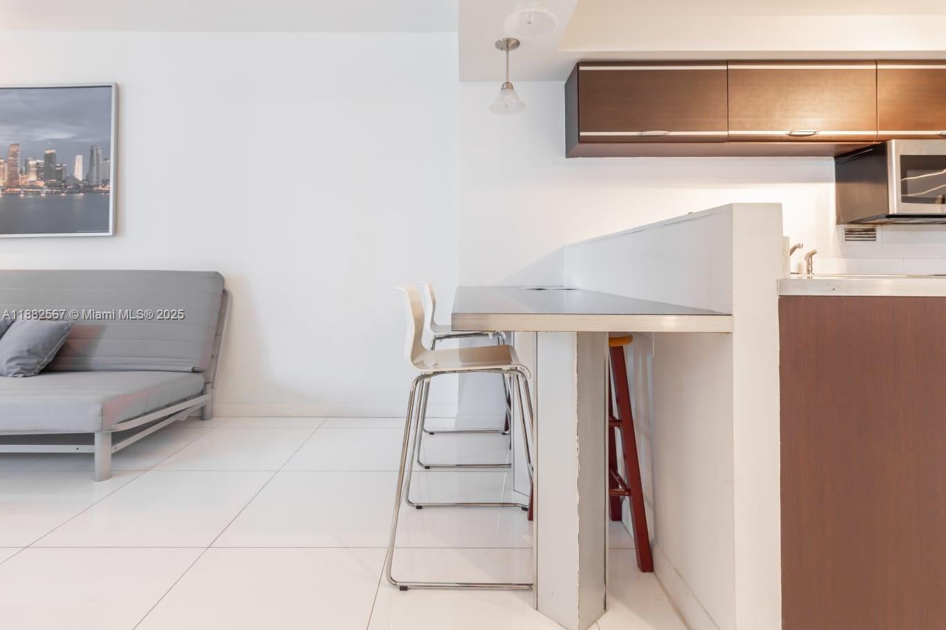 2301 Collins Avenue, Unit 1023 Miami Beach, FL 33139 - Photo 3 of 15 a living room with furniture and a fireplace