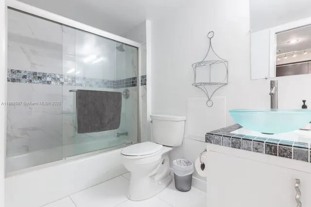 a bathroom with a toilet a sink and shower