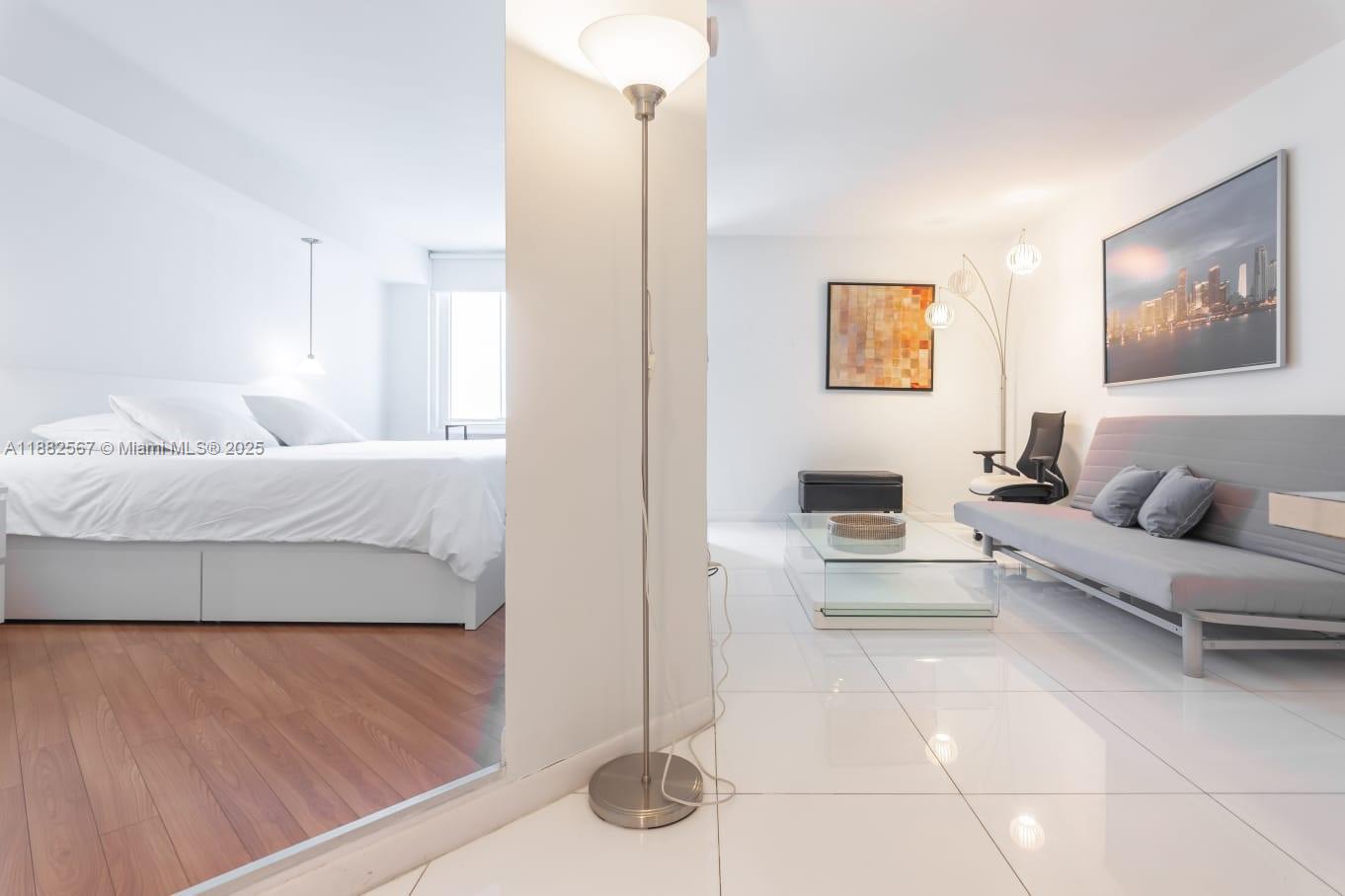 2301 Collins Avenue, Unit 1023 Miami Beach, FL 33139 - Photo 7 of 15 a living room with furniture and a table