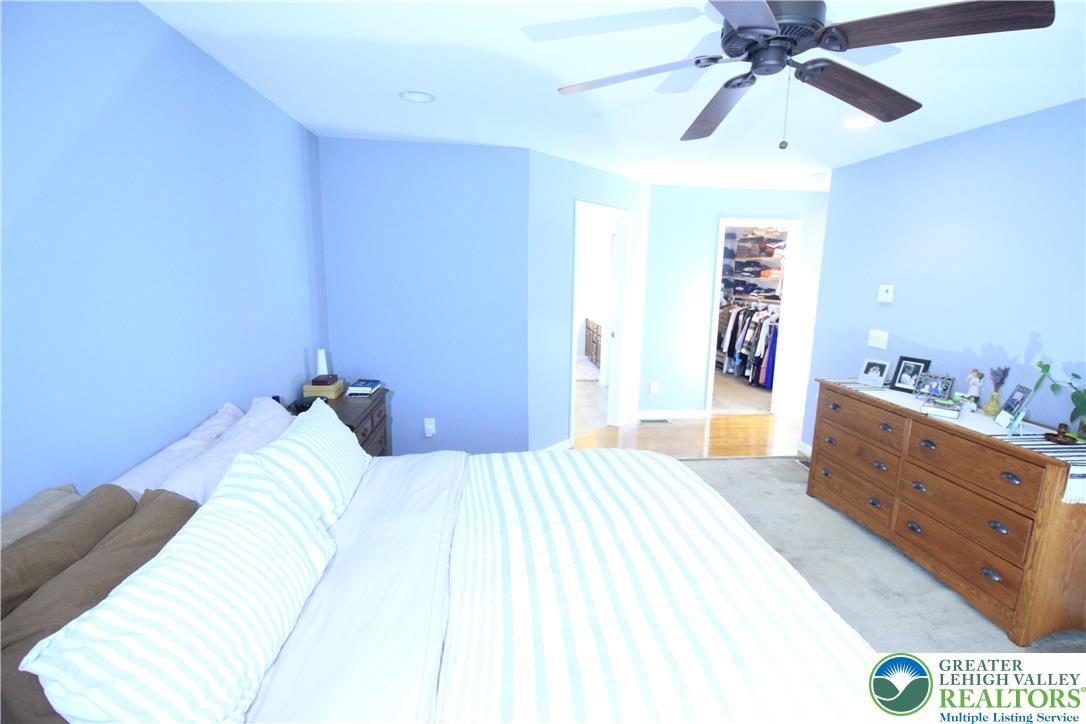 472 Bauer Road Bath, PA 18014 - Photo 16 of 47 a bed room with a bed and a chandelier