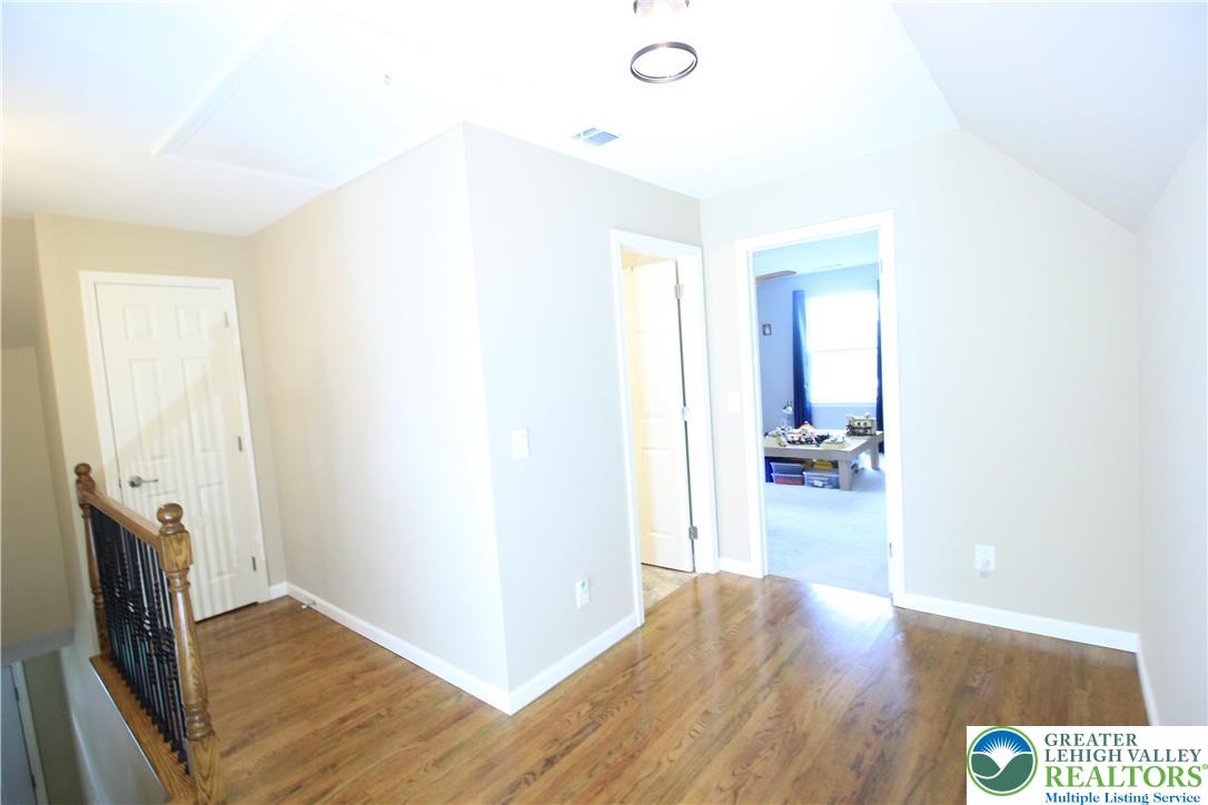 472 Bauer Road Bath, PA 18014 - Photo 19 of 47 a view of a hallway with wooden floor and a living room