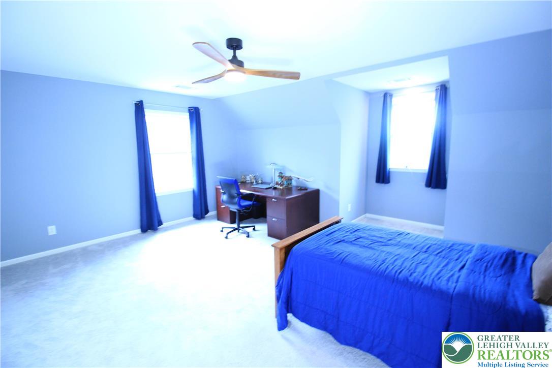 472 Bauer Road Bath, PA 18014 - Photo 23 of 47 a bedroom with a bed and a chandelier