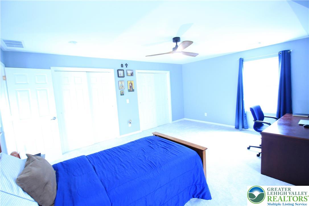 472 Bauer Road Bath, PA 18014 - Photo 24 of 47 a bedroom with a bed and a chandelier