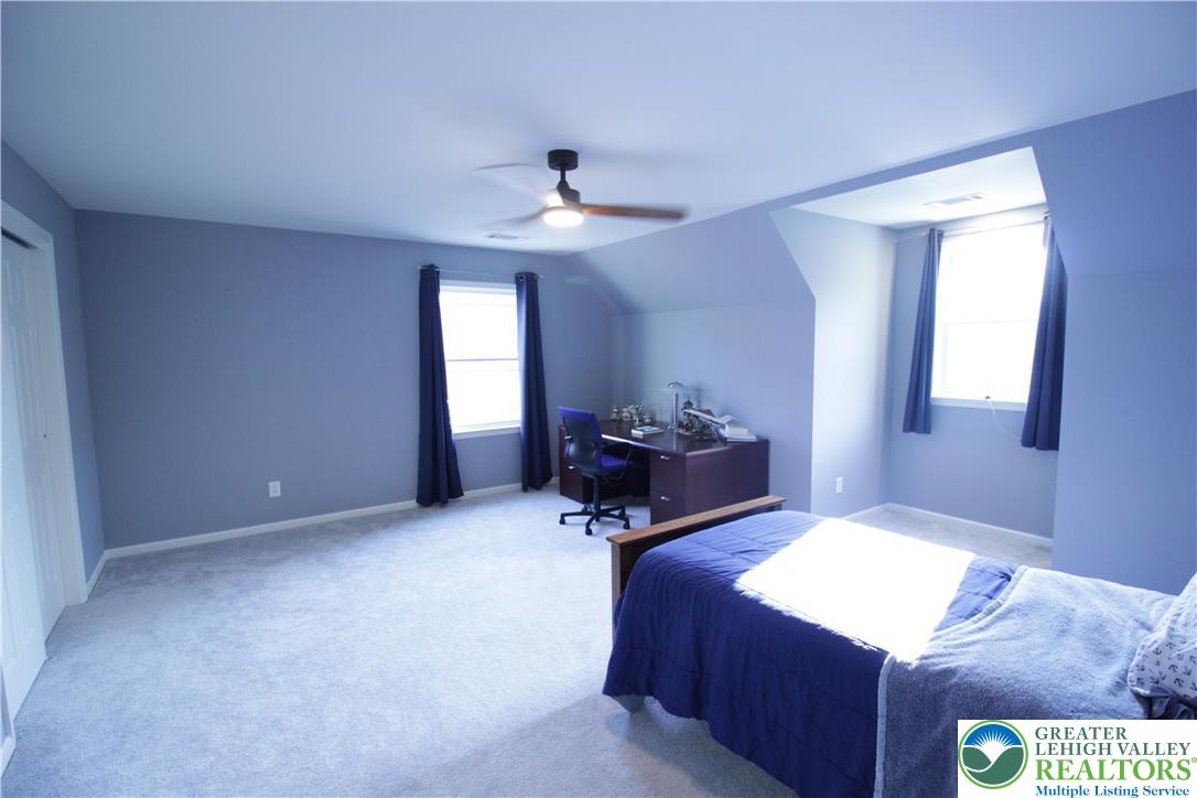 472 Bauer Road Bath, PA 18014 - Photo 25 of 47 a bed room with a bed and a chandelier