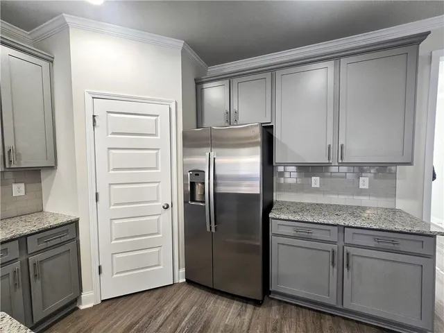 a kitchen with granite countertop cabinets and stainless steel appliances
