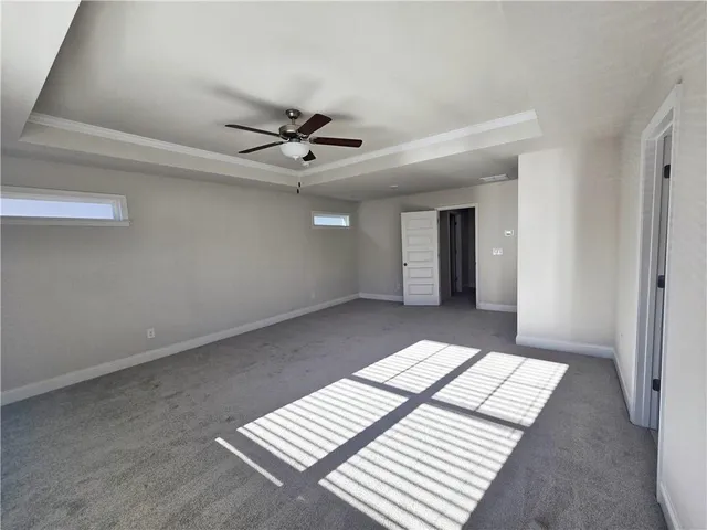 a view of a big room with wooden floor and windows