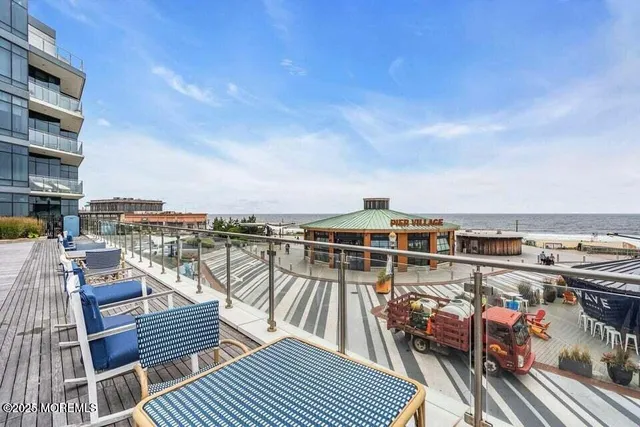 a view of swimming pool with outdoor seating and city view