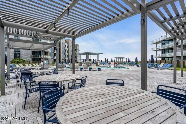 a living room with furniture pool table and a flat screen tv