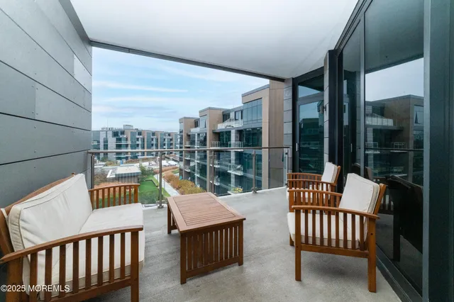a view of a chair and table in the balcony