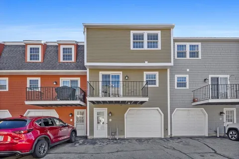a front view of a house with parking space