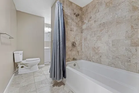 a bathroom with a toilet and a bathtub