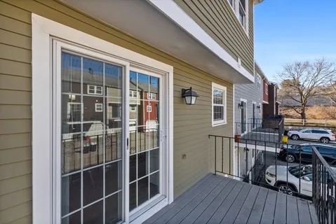 a view of a house with wooden deck and furniture