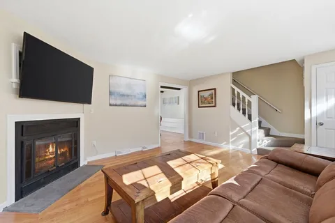 a living room with furniture a flat screen tv and a fireplace